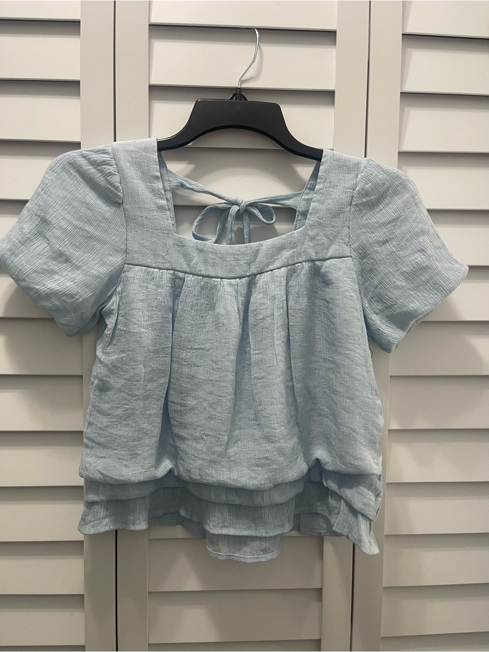 Girl’s Light Blue Square Neck Tie-Back Top. Ruffled 3-tier at the bottom. Size L